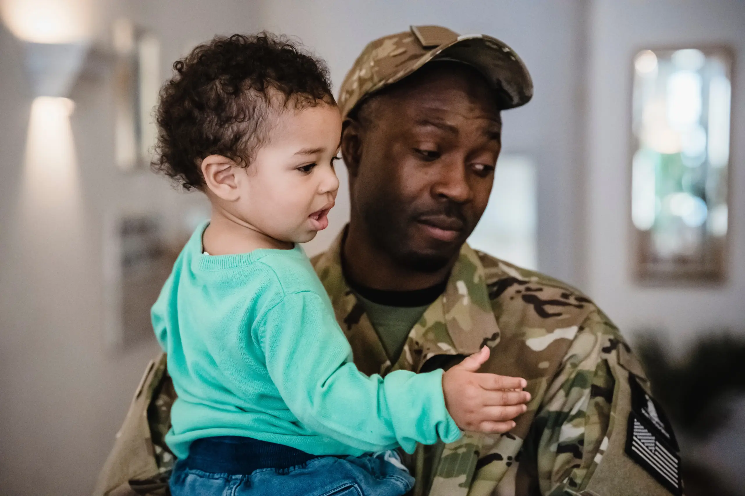 Military Family Attorney client holding a toddler.