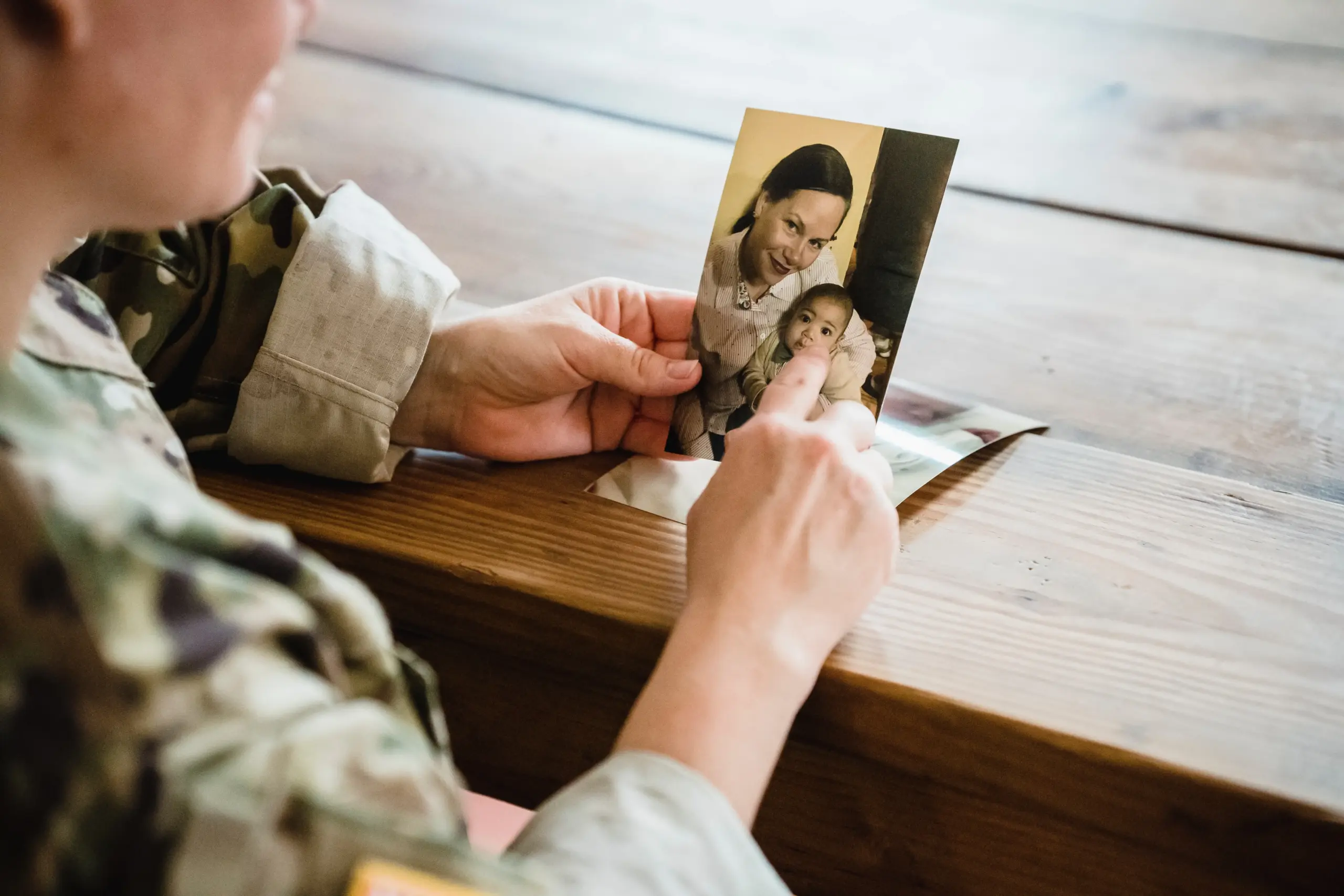 Service member looking at a photo of their family.