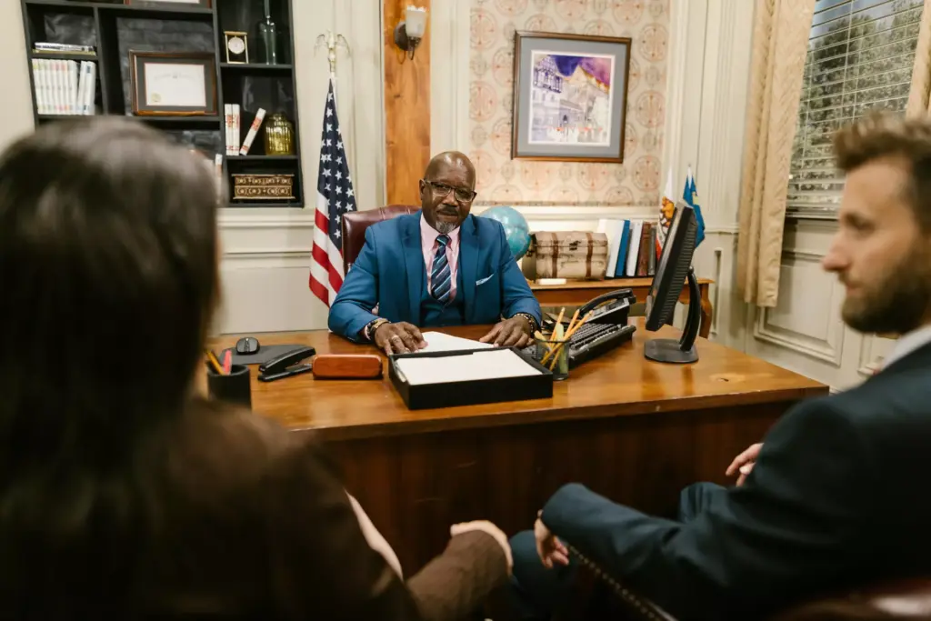 Attorney speaking with his two clients.