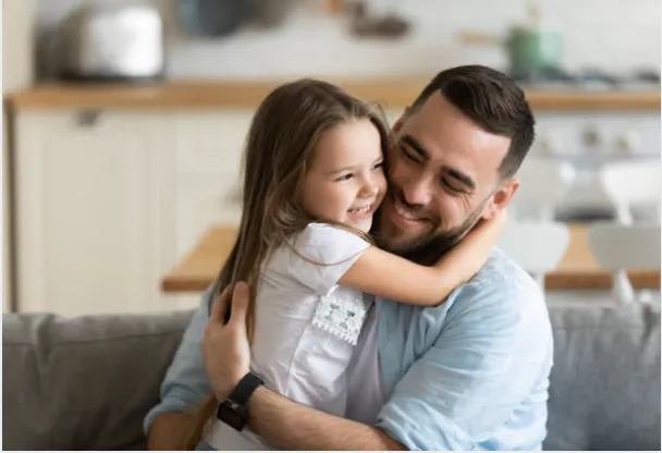 Father and daughter hugging.