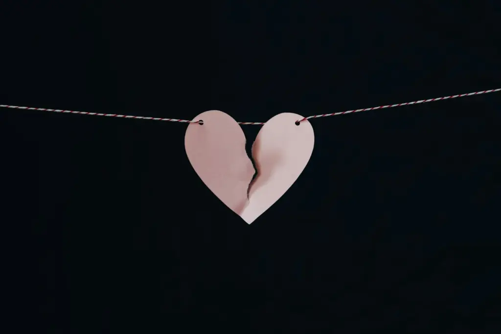 A paper broken heart on a string.