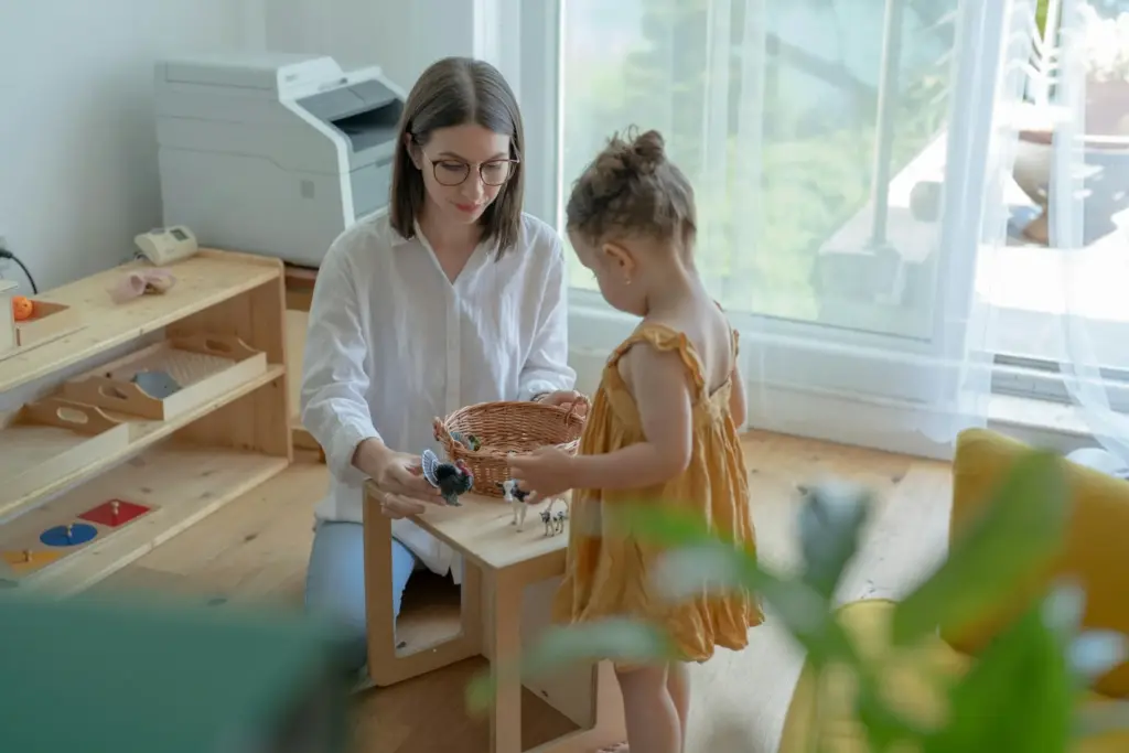 Mother teaching her daughter at home.